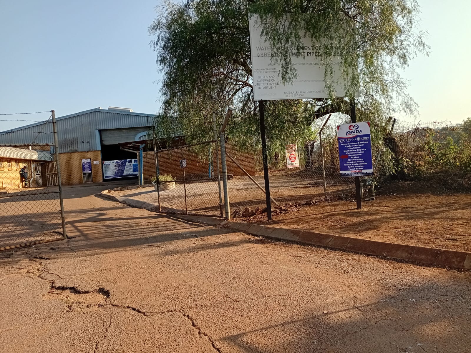 Entrance to Kwatja Motors with signage and services board