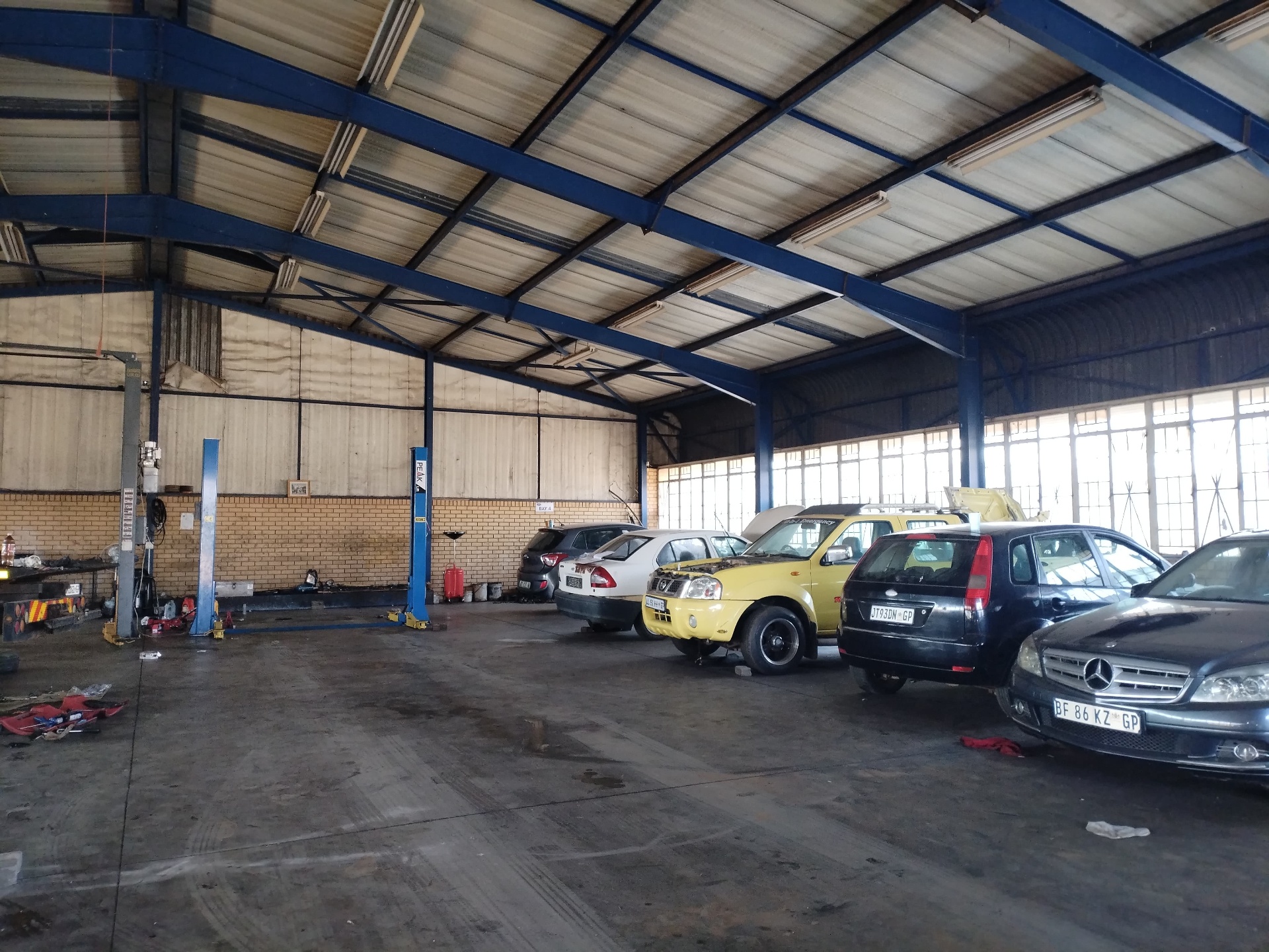 Workshop bays with customer vehicles being serviced
